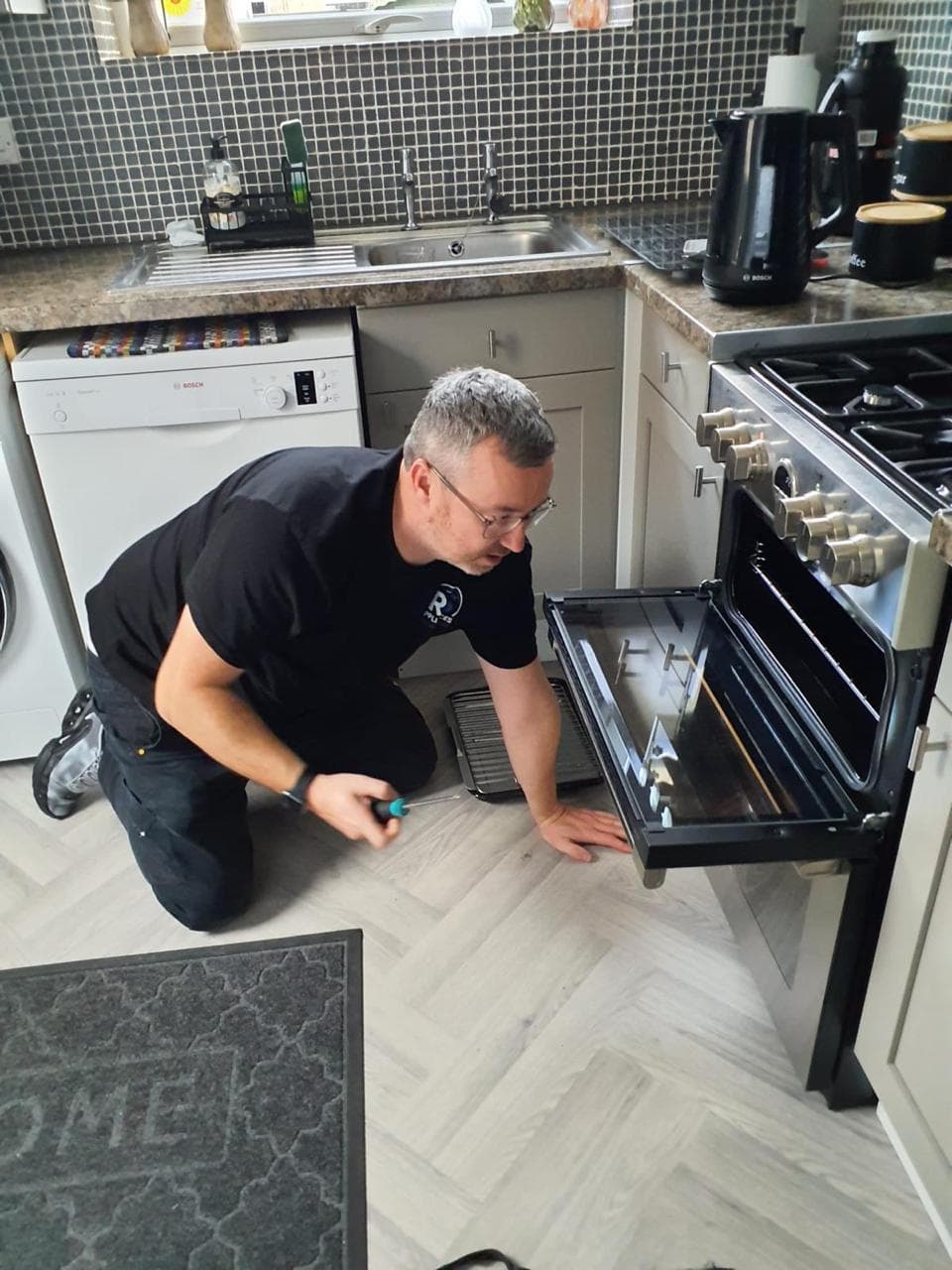 Rob Shields repairing an oven in a domestic kitchen